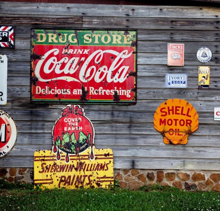 drug store drink coca cola signage on gray wooden wall 210126