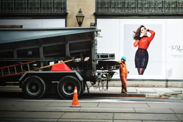 man in orange safety suit standing beside truck bed 94693