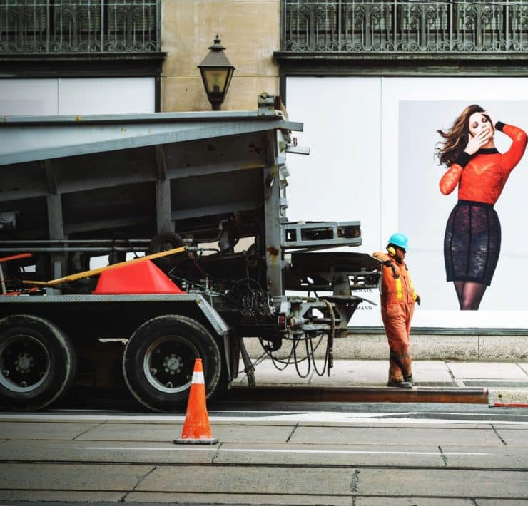 man in orange safety suit standing beside truck bed 94693
