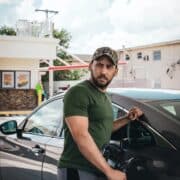 photo of a man fueling up his car