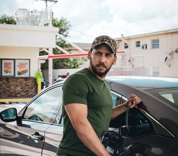 photo of a man fueling up his car