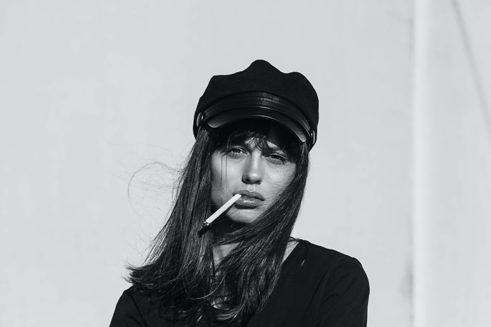 woman wearing black top while smoking 3330159