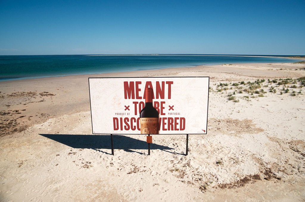 deserted island billboard comes with a glass of wine