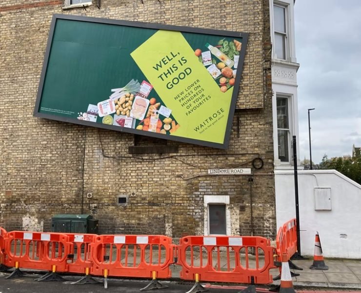 wonky waitrose billboard fenced off by london council as stunt backfires