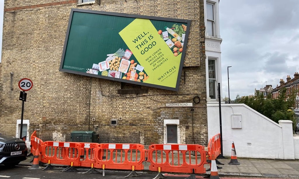 wonky waitrose billboard fenced off by london council as stunt backfires